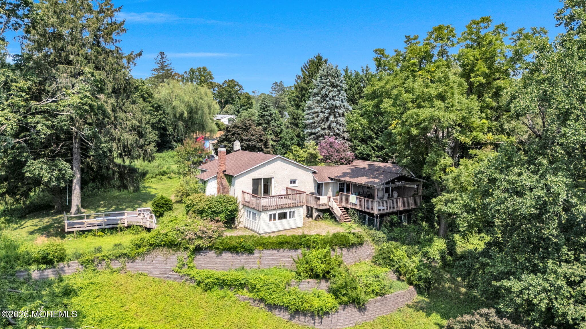 This charming home is nestled privately in acres of woods, yet minutes to the Fast Ferry to Manhattan, the area's beautiful beaches, Netflix Studios, & so much more!