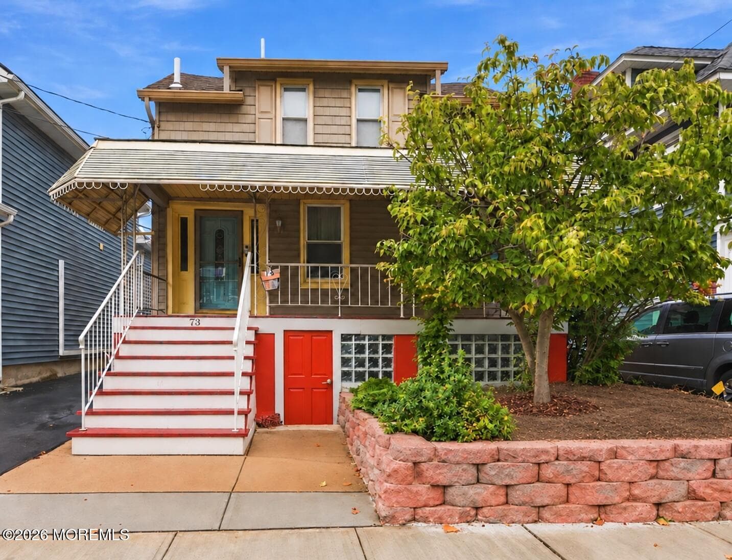 front exterior with a covered porch and landscaped entry.